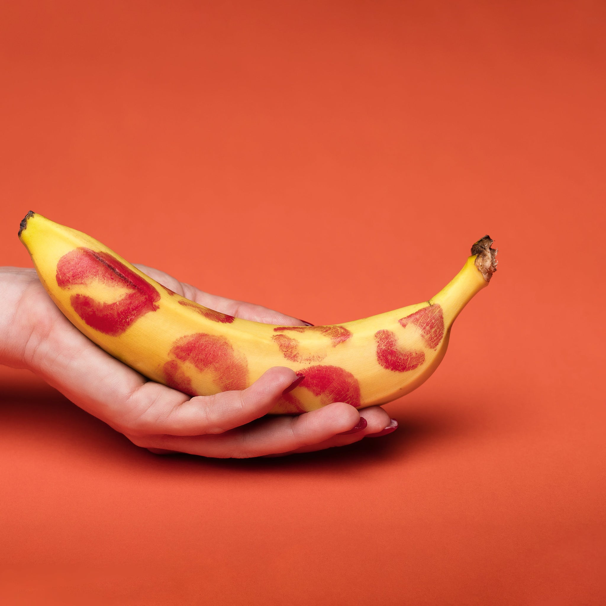 A person holding a yellow banana fruit