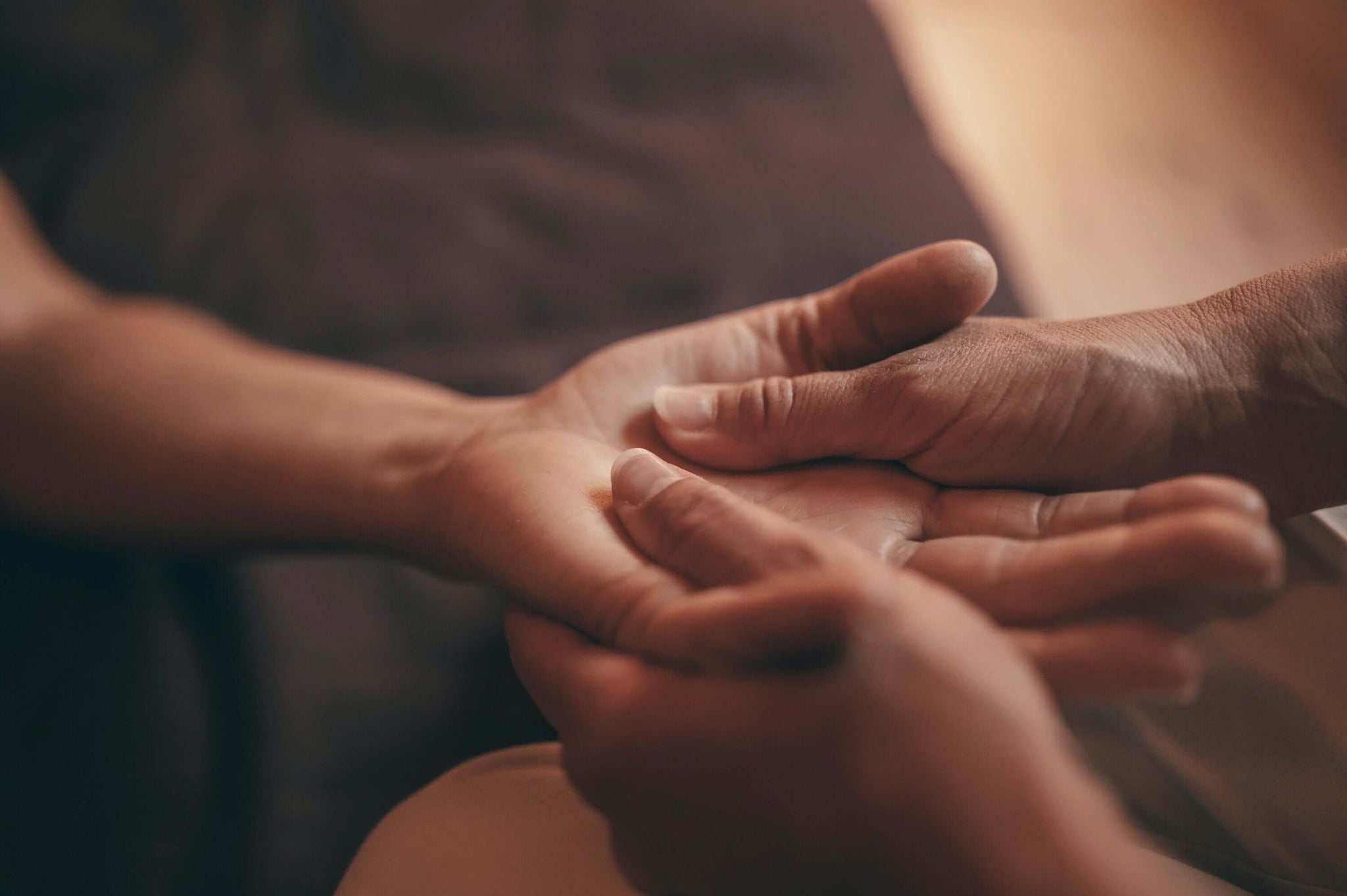 Man giving a massage to a woman on her palm