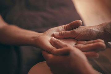 Man giving a massage to a woman on her palm