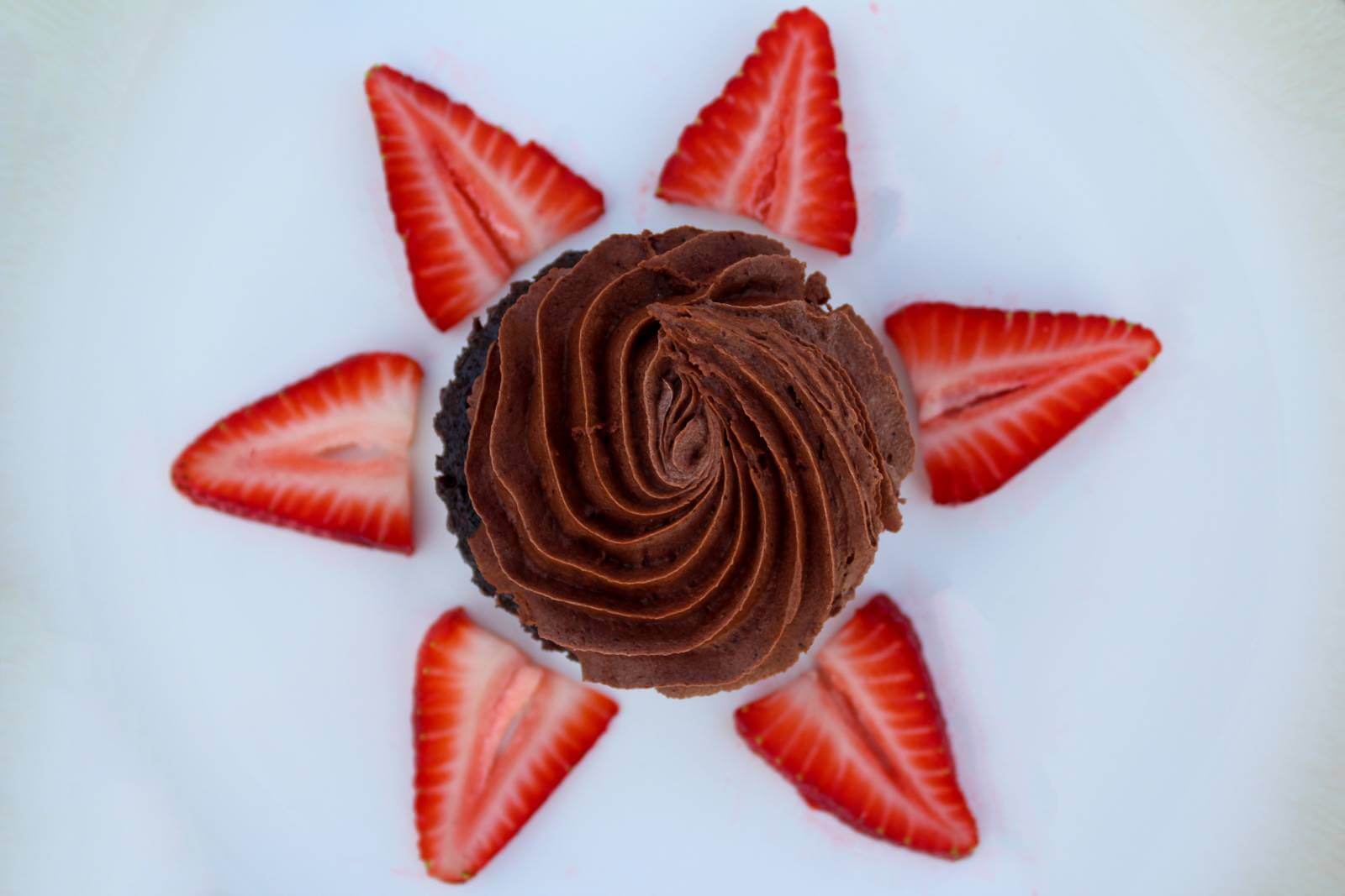 Cupcake with strawberries around it