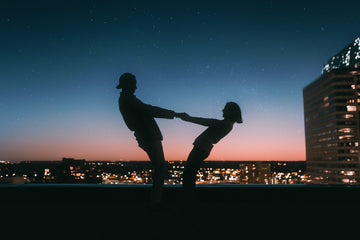 Couple holding hands on the roof 