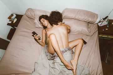 Couple having sex and using smartphones