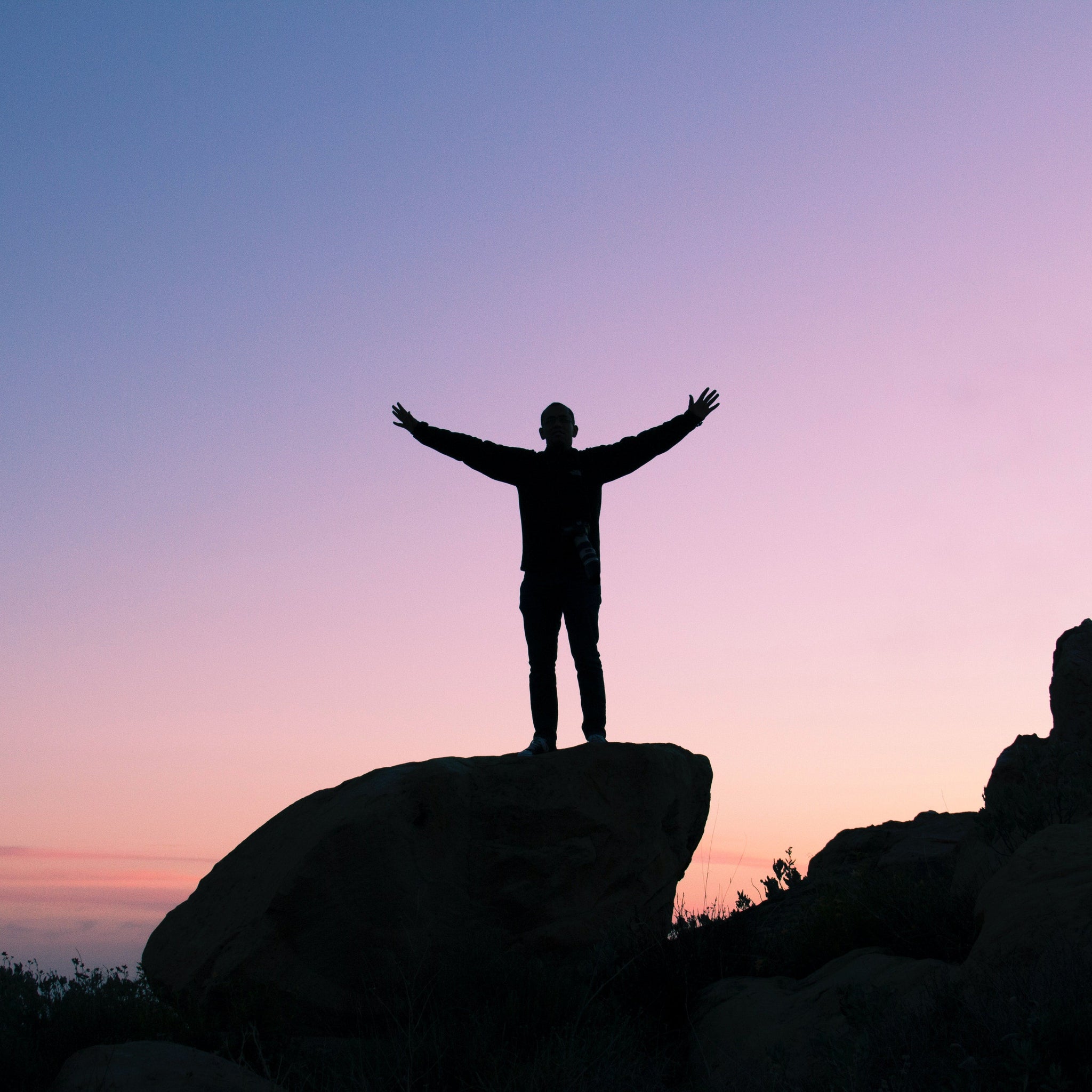 Man standing on the top of a rock