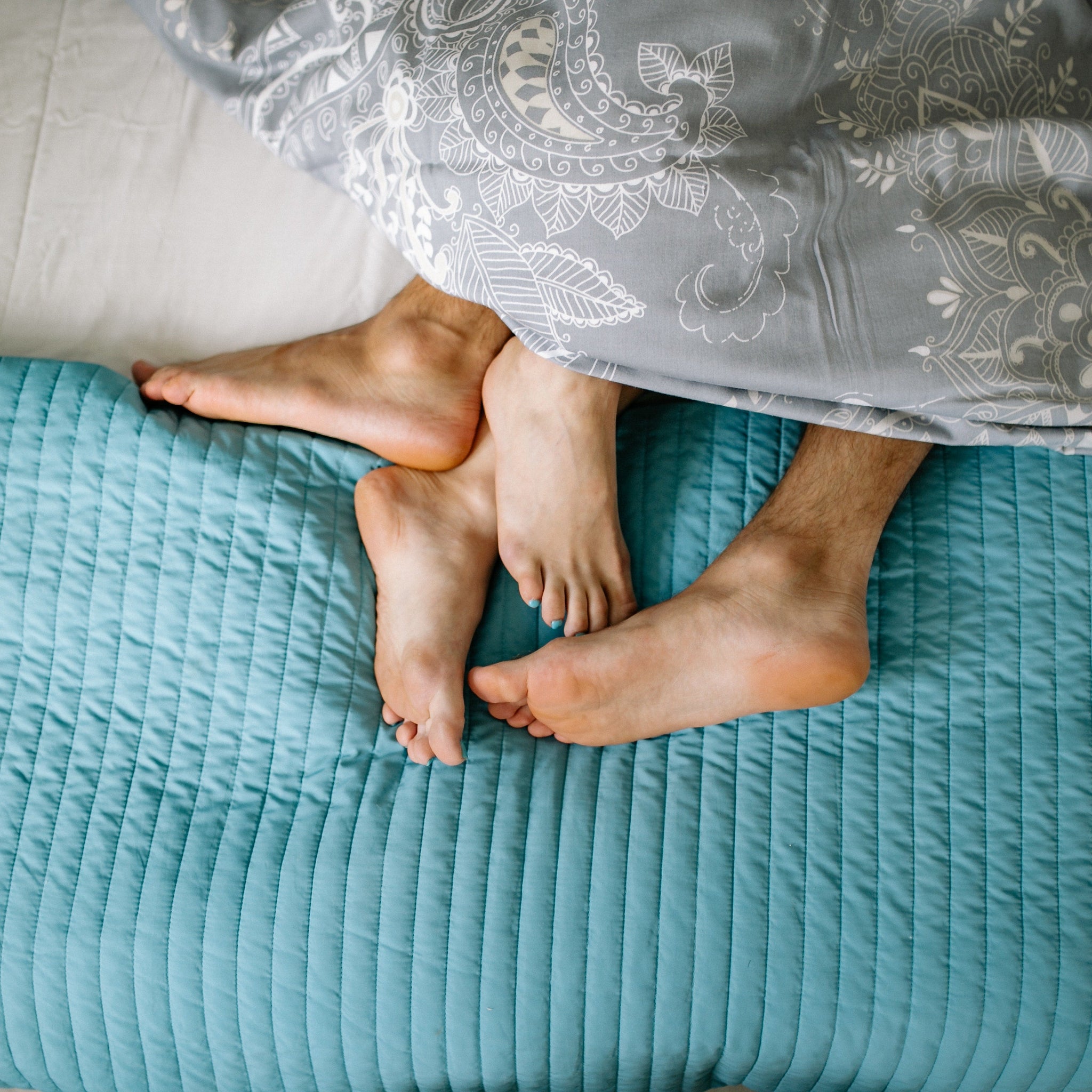  Close-up of Couple Legs Cuddling in Bed