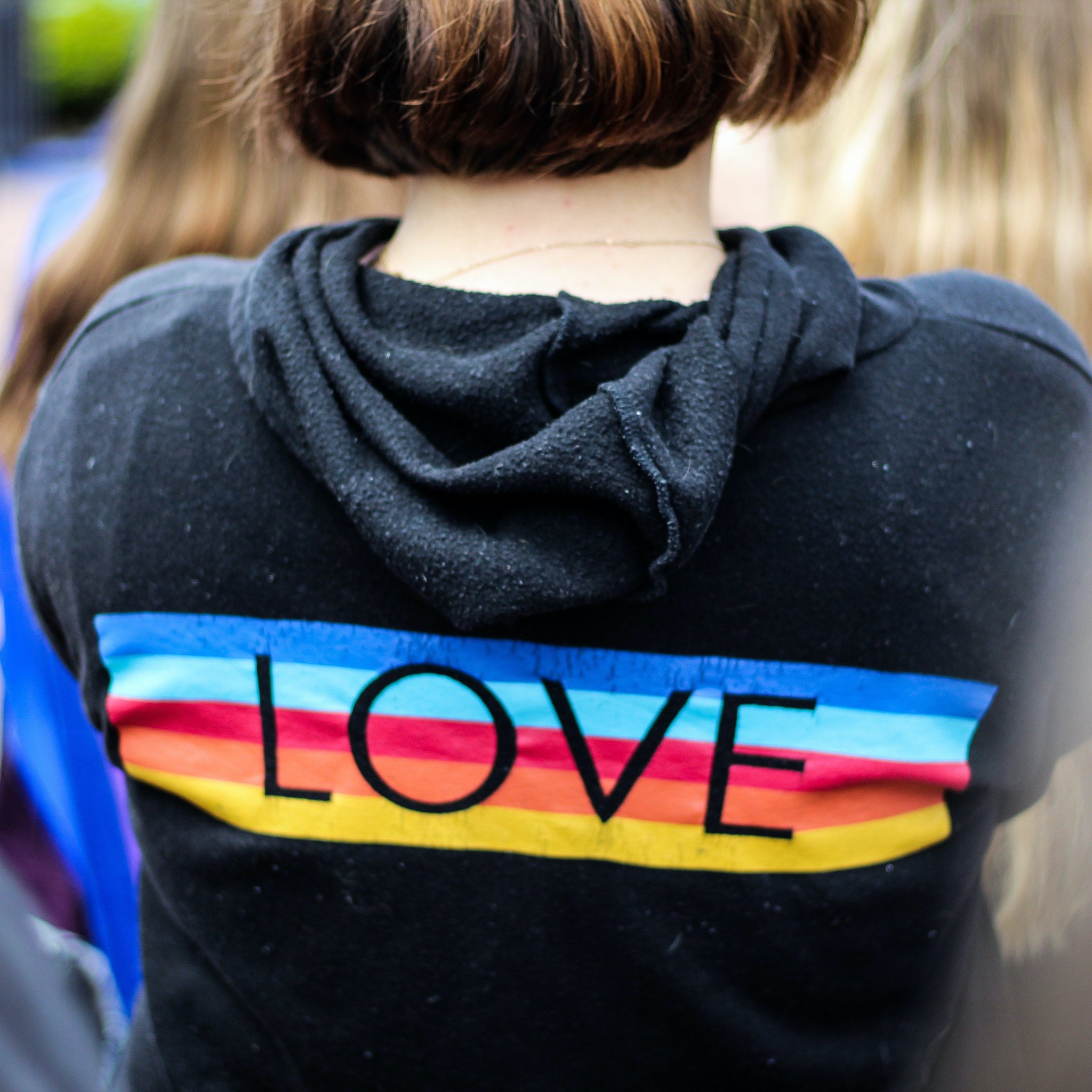 Woman in Black and Multicolored Love Print Hoodie