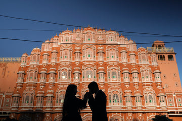 Couple standing in front of the Hawa Mahal in Jaipur, India