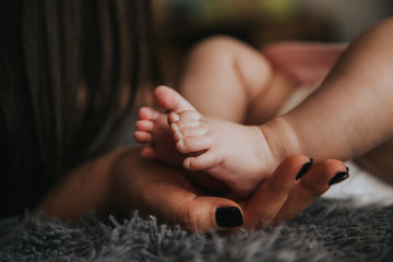 New mom holding her baby's feet