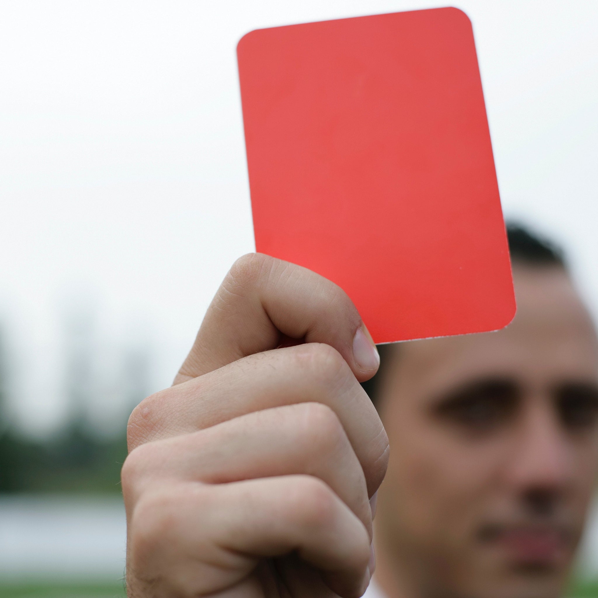 Person holding red card