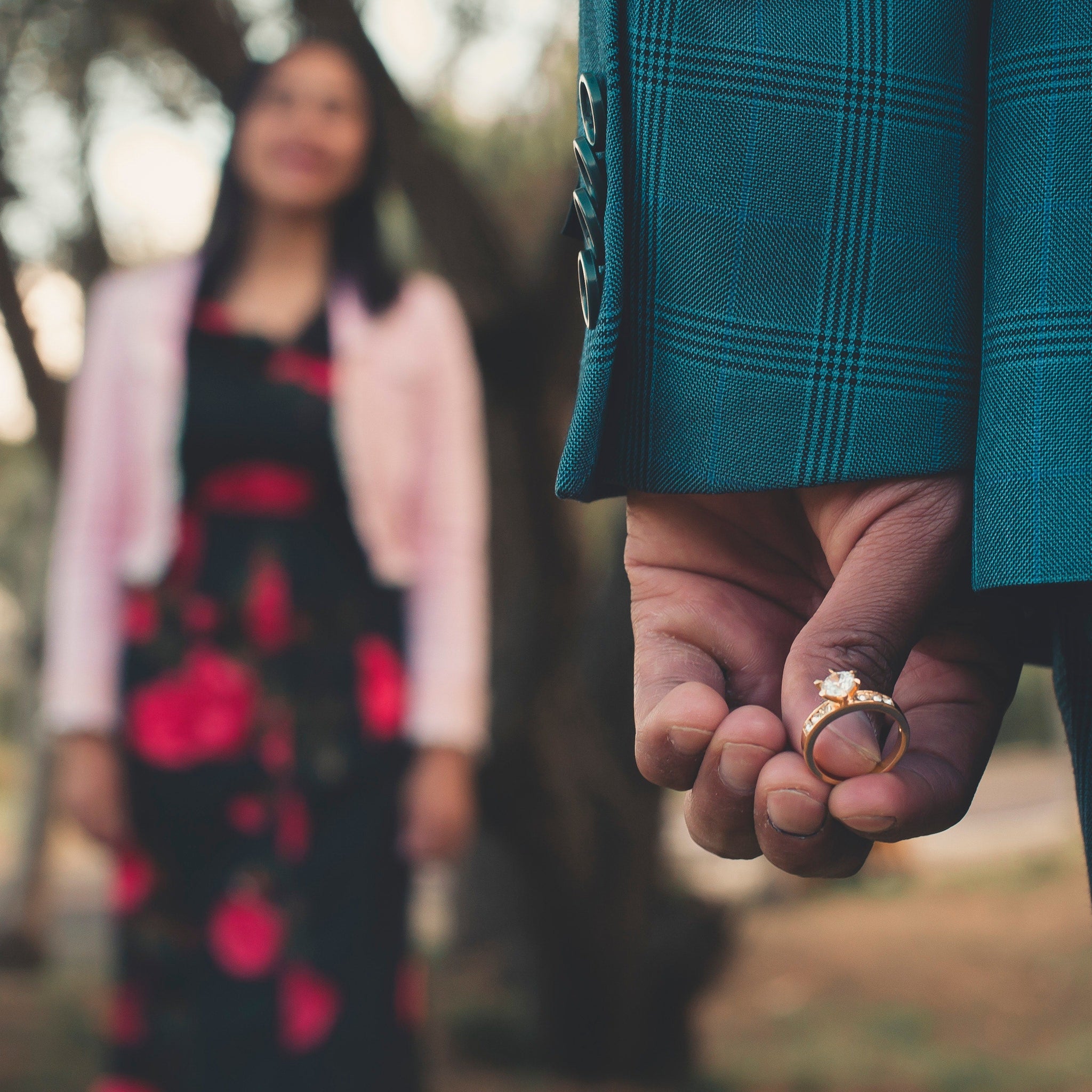 A person holding a diamond ring