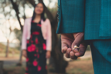 A person holding a diamond ring