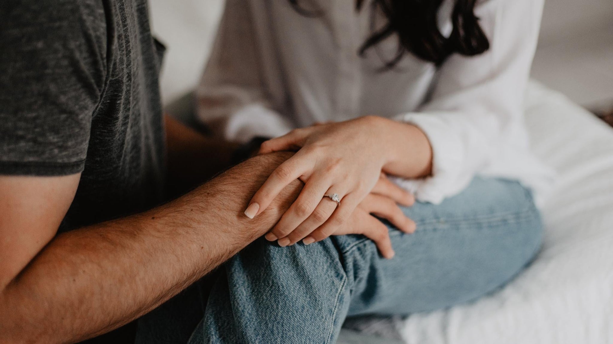 A woman holding a man's hand