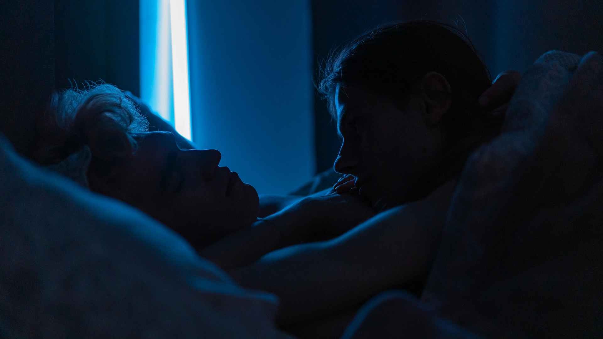 A Man Looking at his Partner while Sleeping