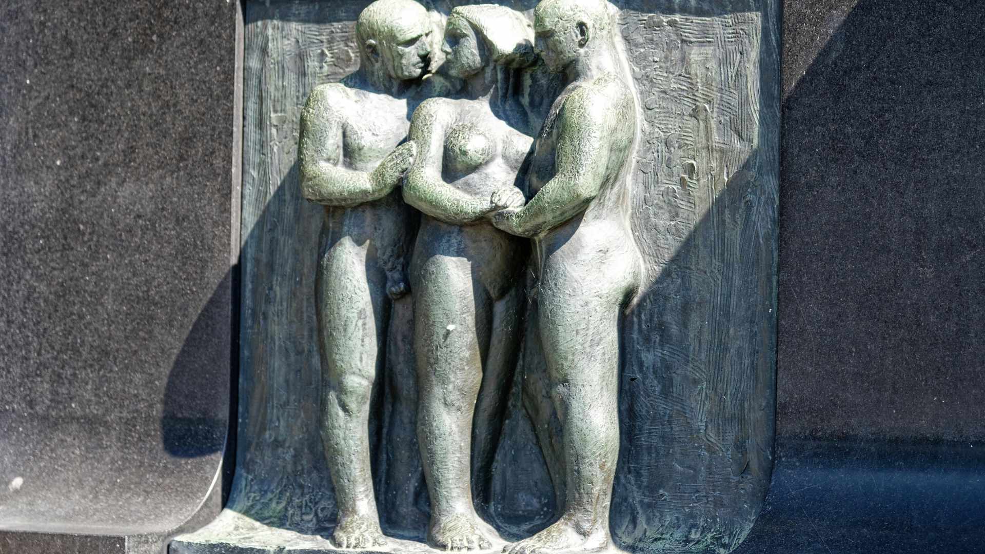 Figurine of Naked Woman Accompanied by Two Nude Men