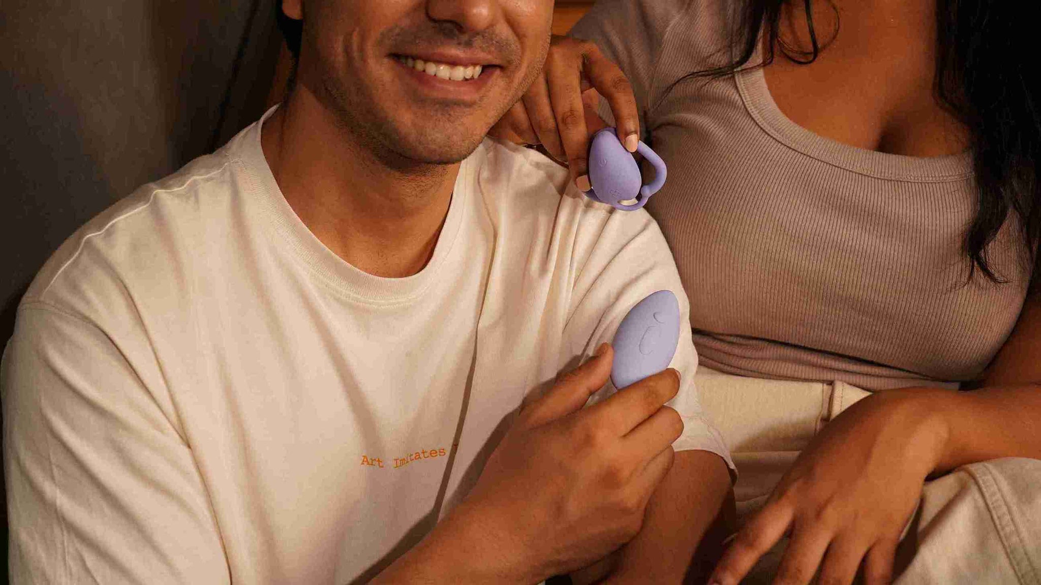 A couple playing with MyMuse’s Throb remote-controlled wearable massager