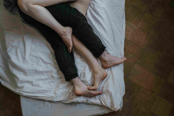A woman and man lying in a bed