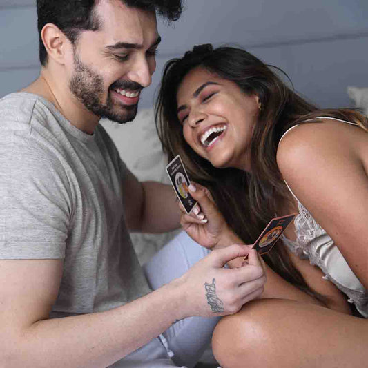 Couple playing MyMuse' Under The Sheets Card Game