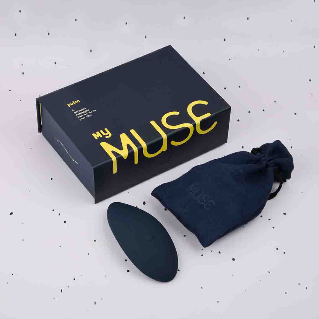 Inverted Palm Massager in inkpen blue colour against a white dotted black background along with its packaging